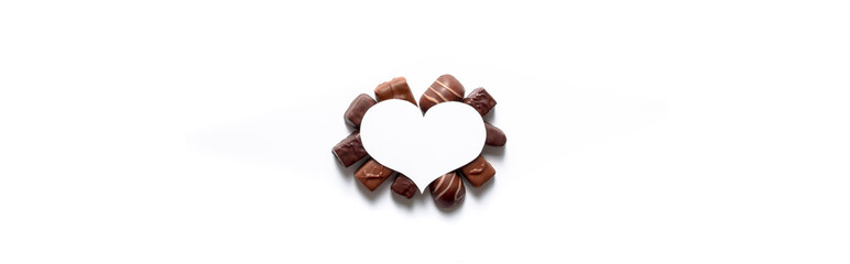on a white background under a white heart a gift for Valentine's Day tasty different chocolates in the form of postcards with copy space
