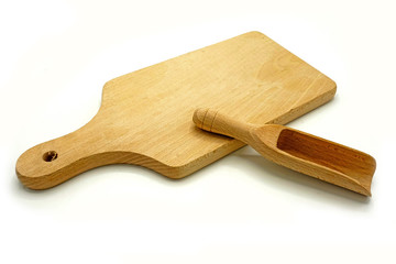 Wooden kitchen utensils on white background. Cutting board and scoop.