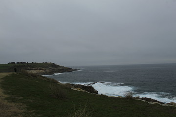 CCliffs, waves and fog in Atlantic Ocean near A coruna.