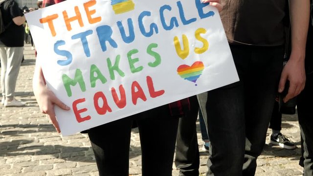 Pride Parade Street Party Celebration with Rainbow flags. Banner The struggle makes us equal