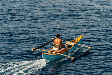 Philippine fisher on banca boat in the morning on island cebu