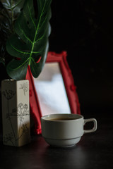 Black coffee in Blue cup on freshly roasted coffee beans background. Top view.