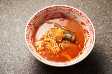 Spicy soup with vegetable in bowl 