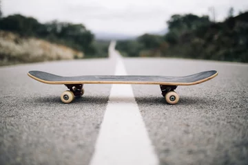Poster wooden skateboard on the road © Sergio