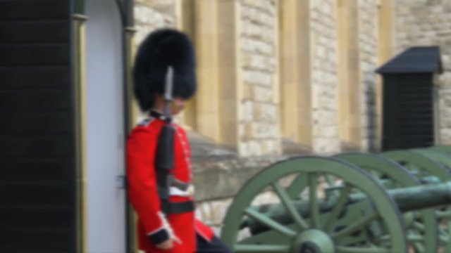 Blurred video footage. Traditional march of the British guard at the combat post. British Guard Soldier of patrols near Tower of London of duty of Queen of England. Queen's Guard - Tower of London.