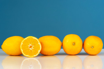 Yellow ripe lemon sliced in half juicy citrus fruit on the white table in front of the blue...