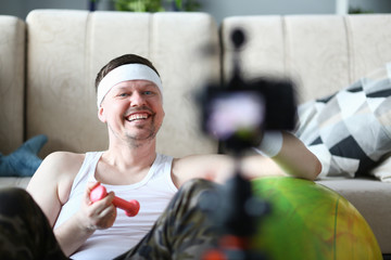 Happy Sportsman Recording Sport Video on Camera. Smiling Vlogger Shooting Exercise with Dumbbell...