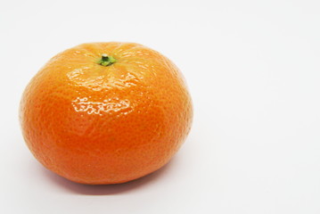 juicy, ripe and fresh tangerine on a light background