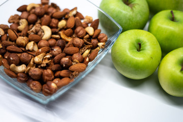 Nuts and apples. Healthy breakfast. Modern white kitchen