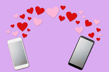 Valentine day concept, love message - hearts flying out of two smartphones with blank screen, Isolated on purple background