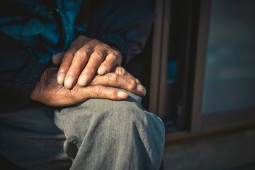 Old man's hands sitting at porch - obrazy, fototapety, plakaty