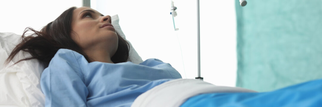 Patient woman lie on bed in ward medical hospital portrait. Chemotherapy tretment concept