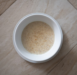 The Boiled oatmeal in a white plate