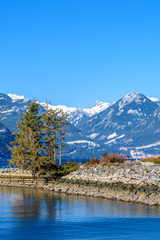 Fantastic view over ocean, snow mountain and rocks at Furry Creek Dive Site in Vancouver, Canada.