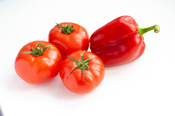 Vegetables sweet pepper and tomatoes on a white background