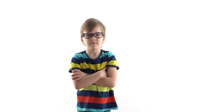studio portrait of a serious boy on a white background. first grader with glasses