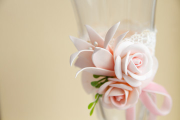 Delicate pink flowers handmade from polymer clay on a glass