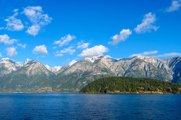 Fantastic view over ocean, snow mountain and rocks at Sechelt inlet in Vancouver, Canada.