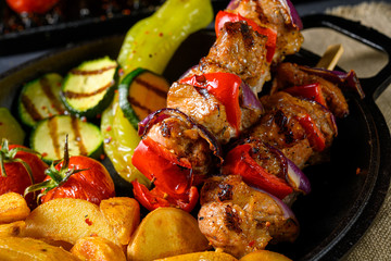 Shish kebab with various vegetables and spice country potatoes