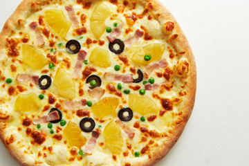 Pineapple and olive pizza on white background 