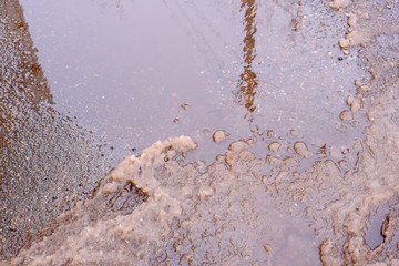 Paved road covered with melting snow