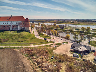 Fototapeta premium Beautiful panoramic aerial drone view to the Sandomierz Royal Castle - planting vines in the vineyard of St. Jakub - near the monastery and Church of St. Jakub in Sandomierz, Poland