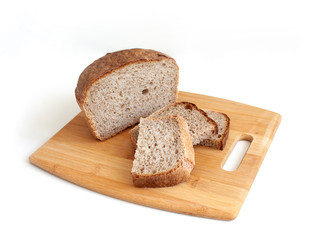 Rye and wheat bread. A piece of bread. A loaf of bread on a cutting board. Isolated image. Food