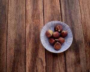 figs on plate on wooden table background