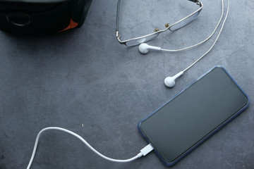 top view of smart phone charging on table 