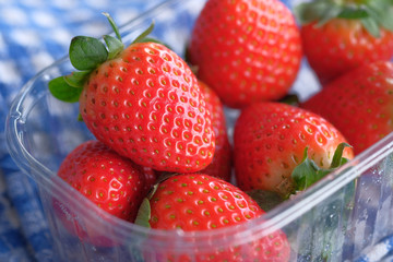 Closeup of fresh strawberry in a box on table 