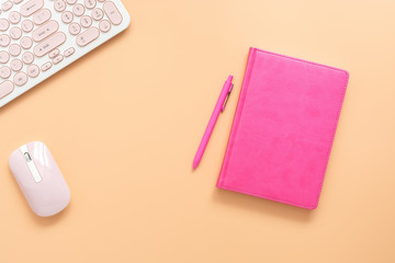 Female workspace, pink notebook, keyboard and mouse on a pastel background. Desktop, home office....