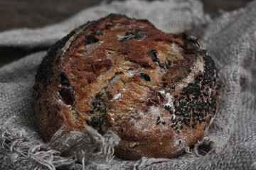 Fresh bread with raisins in hand macro