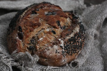 Fresh bread with raisins in hand macro