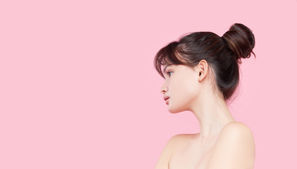 Beautiful young asian korean woman with clean fresh skin touching her own face. Face treatment. Cosmetology, beauty and spa. Pink background - obrazy, fototapety, plakaty
