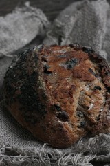 Fresh bread with raisins in hand macro