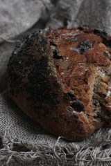 Fresh bread with raisins in hand macro