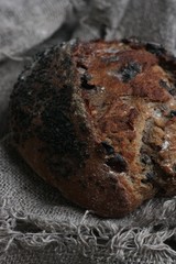 Fresh bread with raisins in hand macro