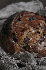 Fresh bread with raisins in hand macro