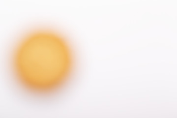 Yellow blurred circle on a white background