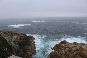 CCliffs, waves and fog in Atlantic Ocean near A coruna.