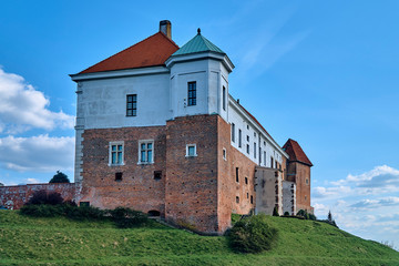 Fototapeta na wymiar Beautiful panoramic aerial drone view to the Sandomierz Royal Castle - medieval structure in Sandomierz, Poland - was built on a slope of Vistula River by Casimir III the Great in the 16th century