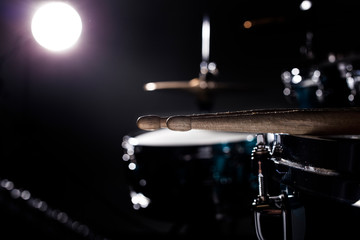 Obraz premium Musical instruments drum kit, flash of light, a beautiful light in the background with copy space