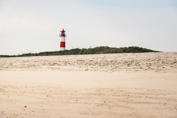 Lighthouse on beach on sunny summer day on Sylt island
