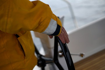 Fototapeta na wymiar White bearded sailing senior, experienced skipper on a sailboat
