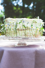 white wedding/birthday cake with field flowers