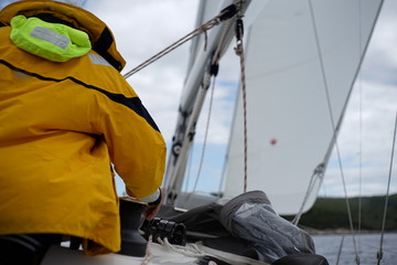 White bearded sailing senior, experienced skipper on a sailboat