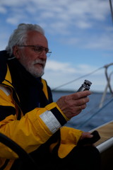 White bearded sailing senior, experienced skipper on a sailboat