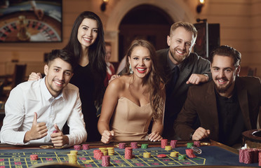 Friends gambling betting in a casino.