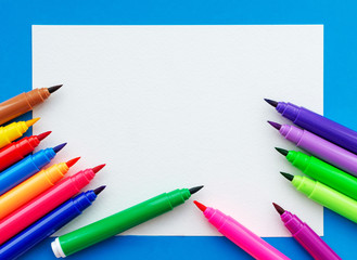 Template. Felt pens on a sheet with a place for inscription. View from above.