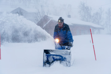 facility manager riding a snowblower in a heavy blizzard in northern Norway